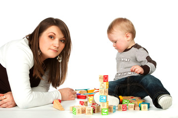 Mother and son playing wooden cubes