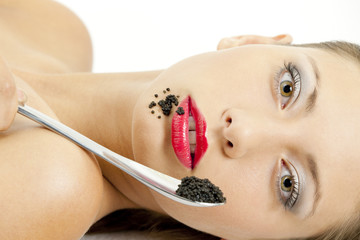 portrait of lying woman with black caviar