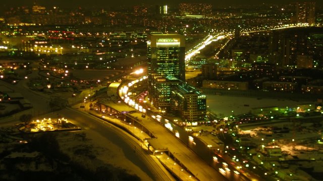 Brisk movement on highway in modern city in night