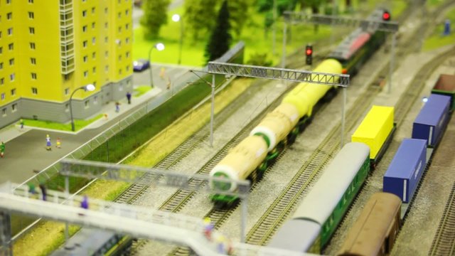 toy train pushes tank wagon on rail in toy city