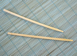 Chinese sticks on a blue bamboo mat