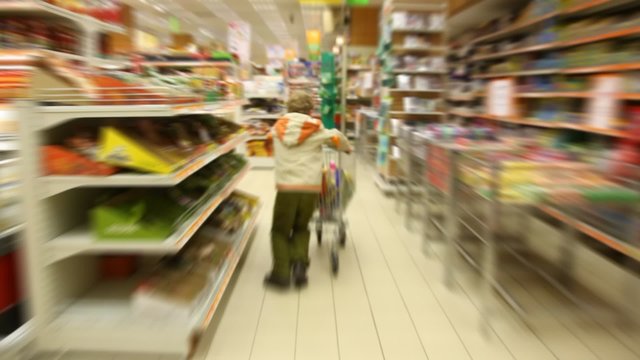 boy moving in supermarket, motion blurred video