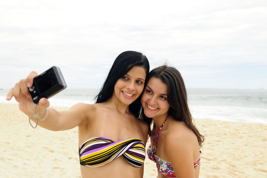 two women taking self-portrait with cellphone