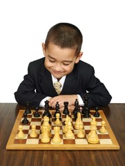 Boy playing chess, smiling, isolated on white