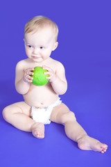 Baby boy is eating green apple