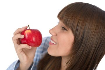 Happy teenager eating healthy apple for breakfast