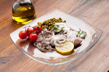 octopus with tomatoes and peas on dish