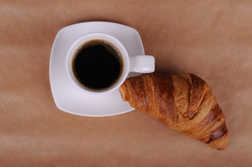 Cup of coffee and croissant