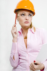 Businesswoman in helmet holding documents