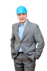 Happy engineer with blue hard hat standing confidently