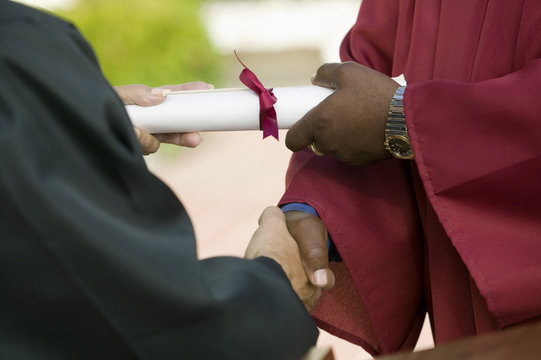 Graduate Receiving Diploma And Handshake