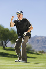 man gesturing on golf course (portrait)