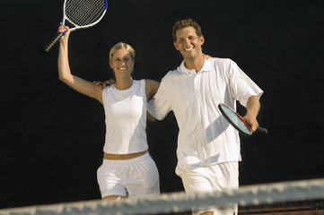 tennis partners skipping side by side arms around celebrating victory
