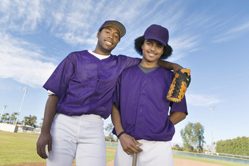 baseball team mates standing on field (portrait)