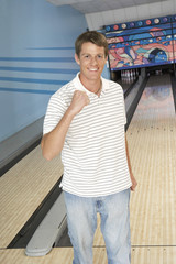 Fototapeta premium young man at bowling alley celebrating portrait