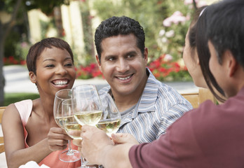 friends drinking wine outdoors head and shoulders