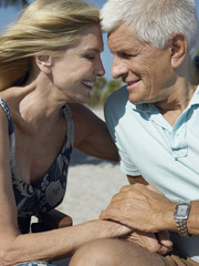 senior couple holding hands on tropical beach close up