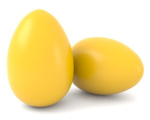 Two golden eggs isolated on white