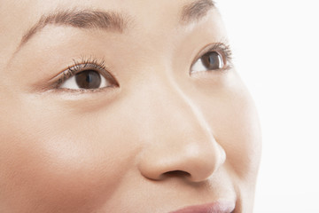 young asian woman's face looking up