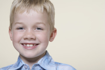 smiling blonde boy close-up