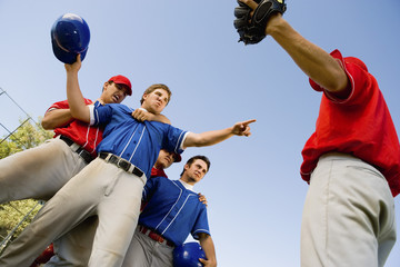 baseball players arguing on field (low angle view)