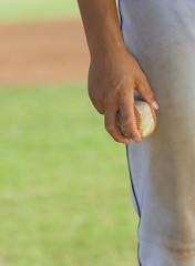 baseball pitcher holding ball (close-up) (mid section)
