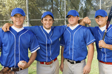four baseball team-mates posing on field (portrait)