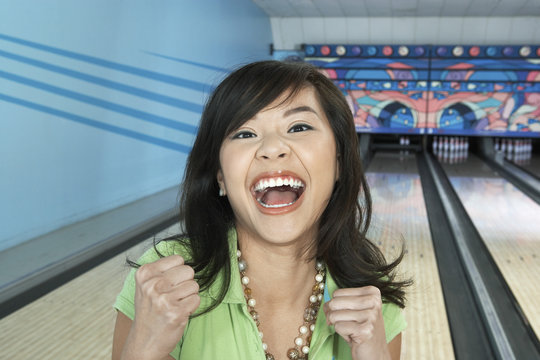 young woman at bowling alley celebrating portrait