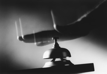 hand hitting service bell (b&w) (close-up)