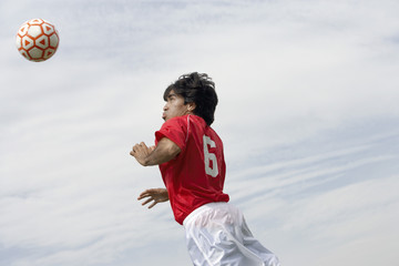 soccer player heading ball portrait