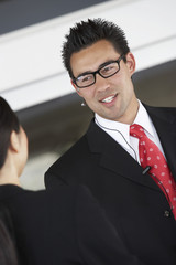 businessman using hands free kit half-length