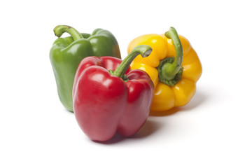 Tricolore bell peppers on white background