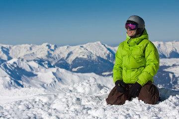 Fototapeta na wymiar Young man on snow in mountains