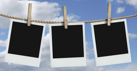 three polaroids hanging with blue sky