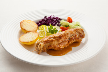 Roasted stuffed pork chop with chips and vegetables