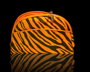 cosmetic bag on black background