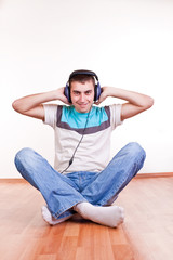 young man on the floor with earphones