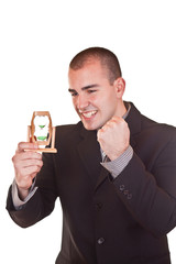 successful businessman holding hourglass
