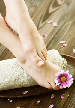 Beautiful Woman Feet with flower.Spa or pedicure concept