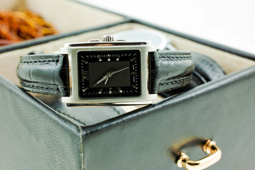 black with silver female watch in a jewelery case