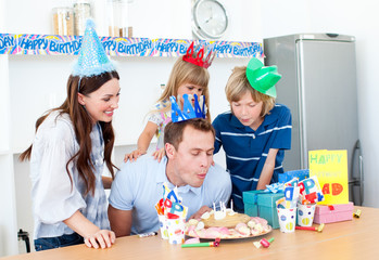 Elegant man celebrating his birthday with his wife and his child