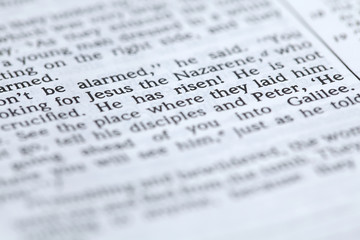 Open Bible with focus on text in Mark 16:6: "He has risen"