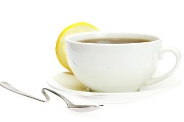 white cup, a spoon and a lemon isolated on white
