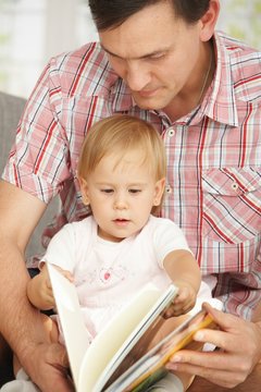 Father And Baby Reading Book