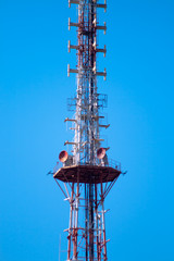telecommunications tower over blue sky