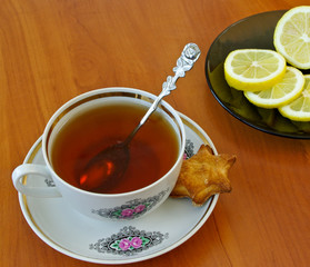 Cup of tea, homemade cookie and lemon slices for breakfast