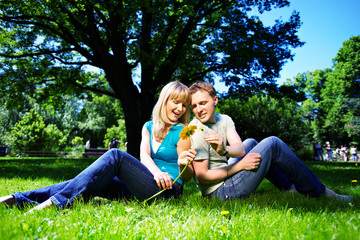 Happy man and woman with flowers