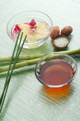 flower in bowl with incense and oil massage spa