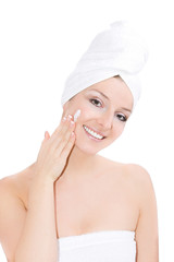 Towel on head blonde caucasian woman creaming face