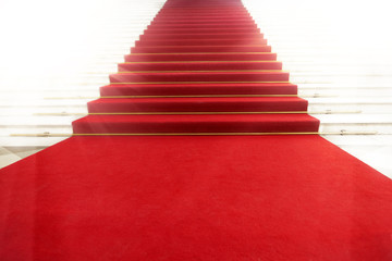 Staircase with red carpet, illuminated by light © Miramiska